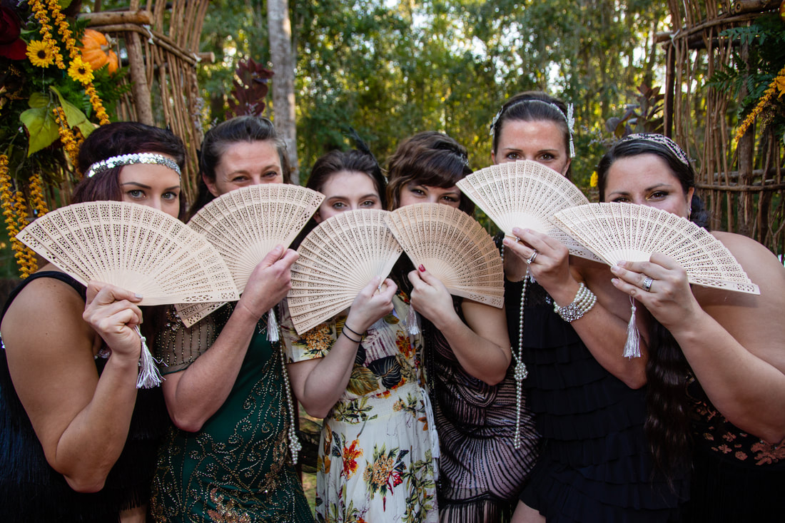 Wedding guests celebrating together with fans